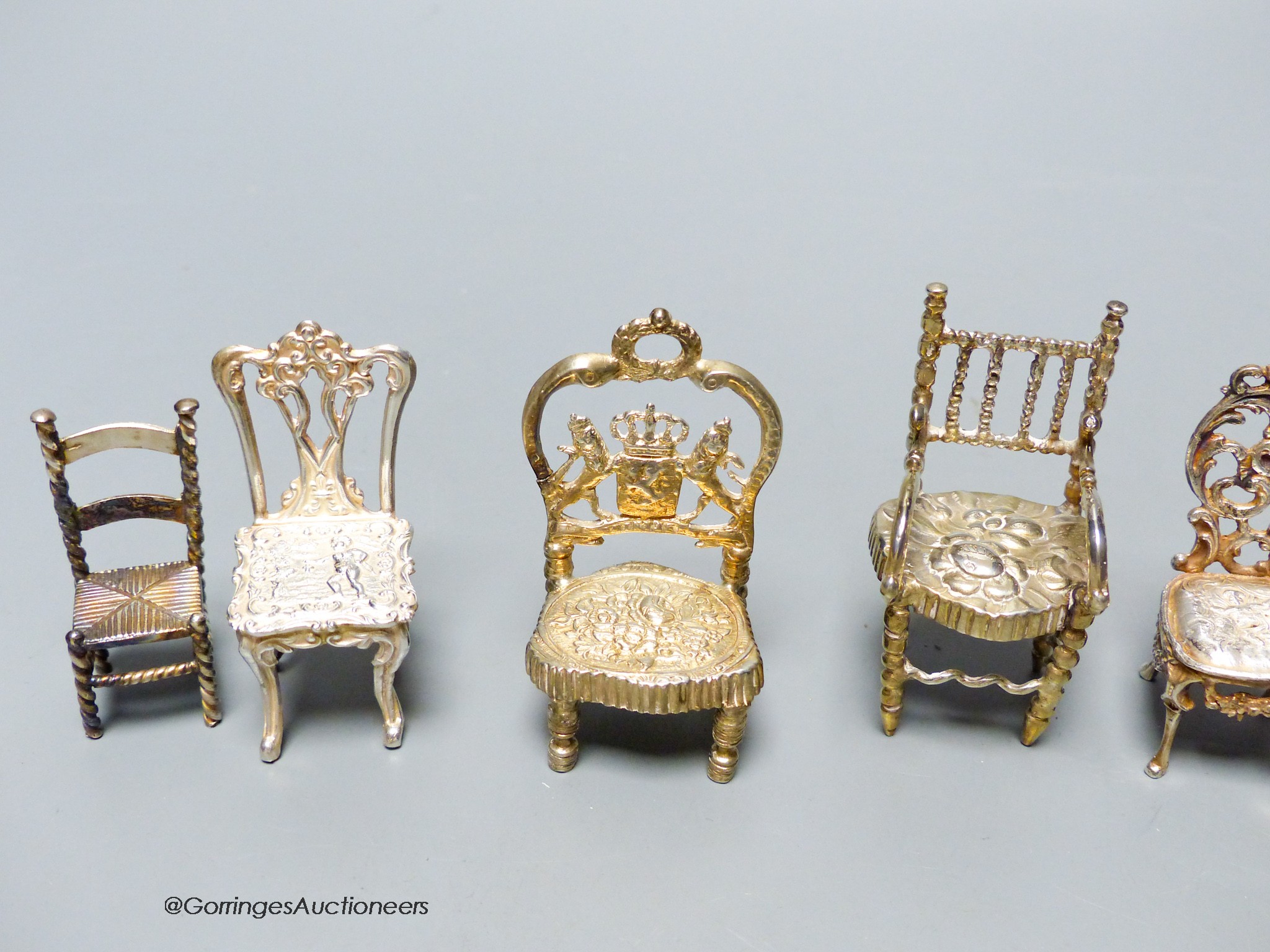 A late Victorian miniature silver model of a chair, 57mm, one other Edwardian chair, two pairs of modern silver chairs and three continental chairs including Dutch.